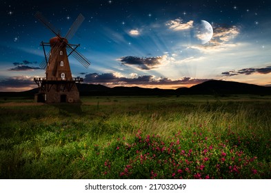 Windmill in the night. Elements of this image furnished by NASA.