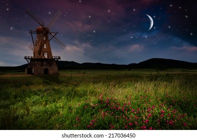 Windmill in the night. Elements of this image furnished by NASA.