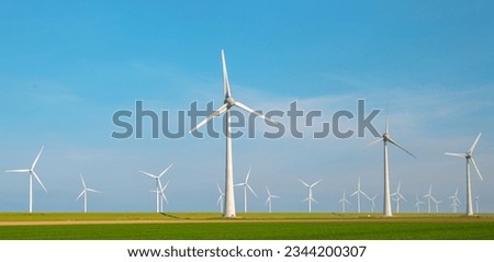 Windmill park with clouds and a blue sky, windmill park in the ocean aerial view with wind turbine Flevoland Netherlands Ijsselmeer. Green Energy production in the Netherlands