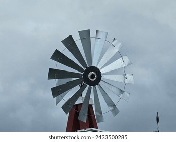 Windmill. Silver windmill. Cloudy day.