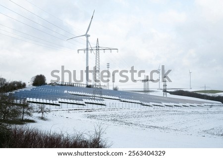 Windmill with solar panel in snow, dark doldrums or wind lull in winter, no renewable sustainable energy, environmental conversation