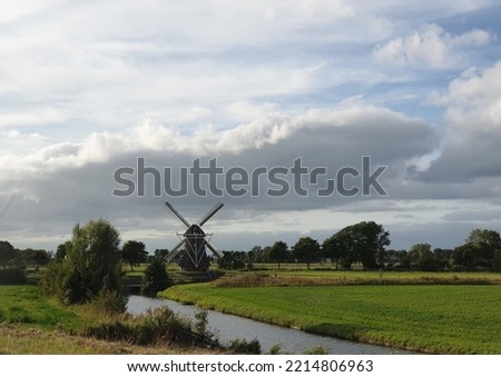 Windmill in a traditional dutch landscape