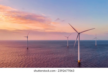 Windmill turbines in the Netherlands at sunset, windmill turbine park in the ocean the biggest wind park in the Netherlands - Powered by Shutterstock