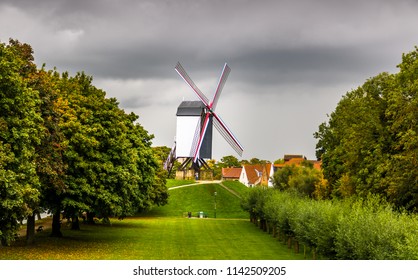 Windmill under cloudy sky