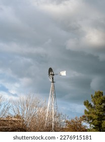 Windmill under a cloudy sky.