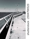 Windmills along the dike at harbor Eemshaven in Groningen, the Netherlands, sustainable energy source