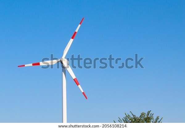 Windmills for\
electricity generation. Green energy concept. Background with copy\
space for text. Huge blades close\
up.