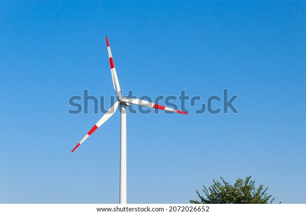 Windmills for\
electricity generation. Green energy concept. Background with copy\
space for text. Huge blades close\
up.