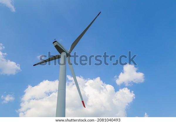Windmills for
electricity generation. Green energy concept. Background with copy
space for text. Huge blades close
up.