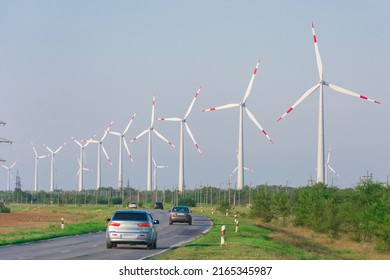 Windmills Generators Of Electricity. Highway Next To A Source Of Alternative Electricity. Ecological Renewable Power Sources.