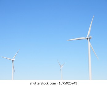 Windmills on clear blue sky - renewable energy - alternative energy