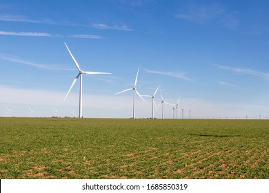 Windmills Scattered In Agricultural Field In The Texas Plains