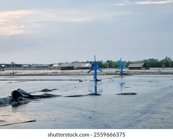 The windmills in traditional salt ponds to regulate the flow of irrigation water - Powered by Shutterstock