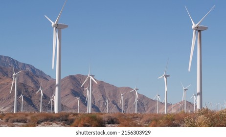Windmills turbine rotating, wind farm power plant, alternative green renewable energy generators, industrial field in California desert USA. Electricity generation on windfarm. Palm Springs, Coachella - Shutterstock ID 2156303929