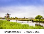 Windmills and water canal in Kinderdijk, Holland or Netherlands. Unesco world heritage site. Europe.