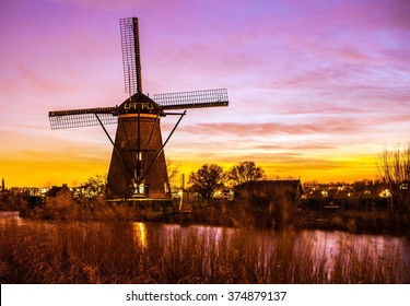 Windmills and water canal on sunset in Kinderdijk, Holland.  - Powered by Shutterstock