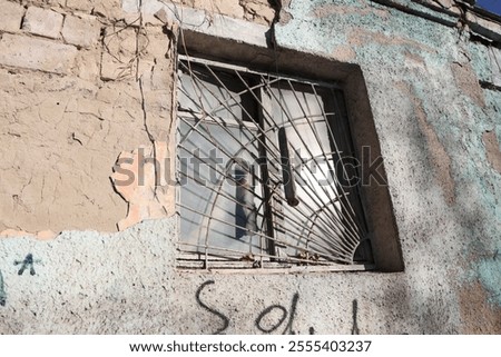 A Window of an Abandoned Building Featuring Wornout Bars with a Rich Visual Story