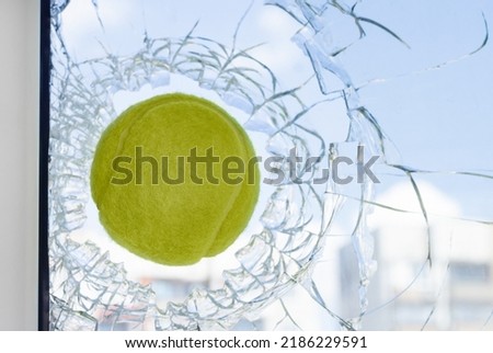 The window is broken by a ball.