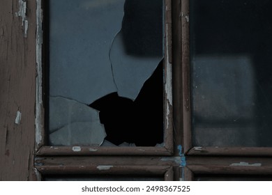 Window with broken glass in old aged building Wooden window frame with partially broken glass in old abandoned wood building. darkness inside - Powered by Shutterstock