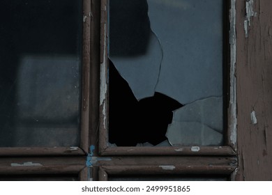 Window with broken glass in old aged building Wooden window frame with partially broken glass in old abandoned wood building. darkness inside - Powered by Shutterstock