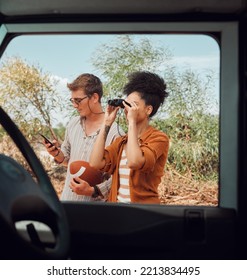 Window, Car And Diversity Couple On Road Trip Journey To Explore Australia Safari, Countryside Or Outdoor Nature. Binocular, Transportation Adventure And Man Streaming Football Game On Mobile Phone