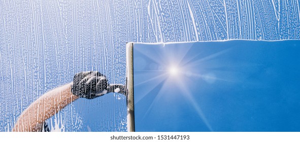 Window cleaner cleans window with foam and puller, banner size
