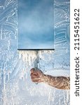Window cleaner using a squeegee to wash a window with clear blue sky