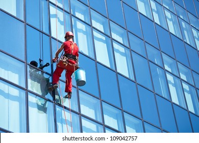 window cleaner working on a glass facade modern skyscraper