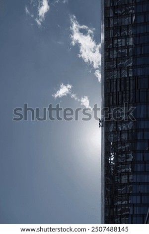 Window cleaners work on the facade of a high-rise building