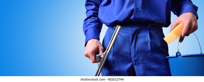 Window cleaning employee with work tools and blue background. Background and concept. horizontal composition.