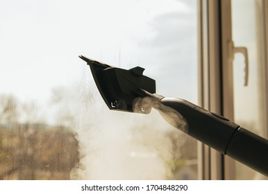 Window Cleaning With A Steam Cleaner. Steam On The Glass. Steam Treatment.