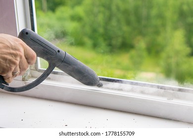 Window Cleaning With A Steam Cleaner. Steam On The Window Frame. Steam Treatment