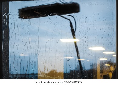 Window Cleaning Using Telescopic Water Brush And Wash System. Commercial Window Cleaning From The Outside With Sky In Background 