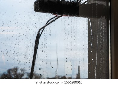 Window Cleaning Using Telescopic Water Brush And Wash System. Commercial Window Cleaning From The Outside With Sky In Background 