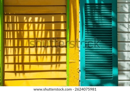 Window of a colorful house with wooden shutters, vibrant colors architecture in Key West, Florida