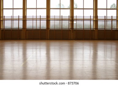 Window Curtain Wall Reflecting At Parquet Floor At School Gym.