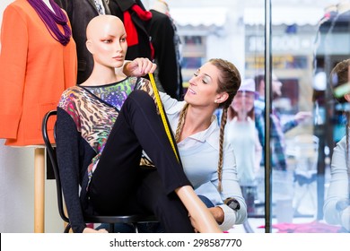 Window Dresser Or Small Business Owner Decorating Shop Display