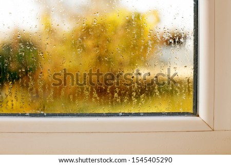 Window drip due to bad ventilation inside house. Condensation on glass during cold weather. High humidity is cause of mold (mildew, mould) on house or building surfaces. Water drop tracks on windows. 