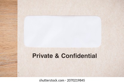 Window Envelope Marked Private And Confidential On A Desk, UK. Blank Envelope For Use As A Template Or Design. 