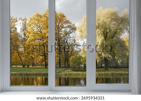   Window frame, view from the window  on yellow trees, landscape with autumn forest.                             