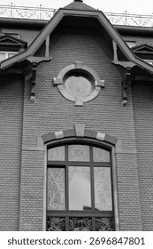 The window front of an old house captured in black and white, revealing texture, symmetry, and the quiet charm of timeworn architecture.