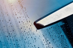 Window glass cleaning with pure water ,Window washing service concept., a close up of a window with rain drops on it, a Photo by showcake