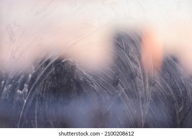 Window Glass With Streaks Of Dirt And A Vague Silhouette Of The City.