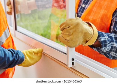 Window installation process made by two construction workers