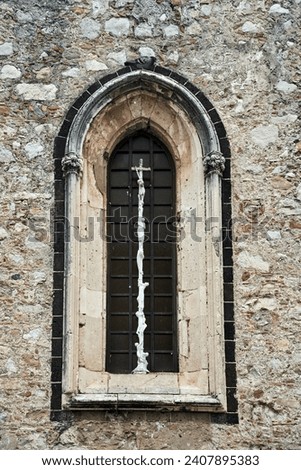 Window of a medieval stone church in Taormina on the island of Sicily, Italy
