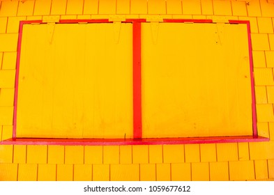 Window With Metal Shutters On Yellow Wall In Philipsburg, Sint Maarten. Facade Of Closed Shop, Small Business. Storefront With Security Blinds. Architecture, Structure And Design.