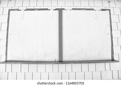 Window With Metal Shutters On Yellow Wall In Philipsburg, Sint Maarten. Facade Of Closed Shop, Small Business. Storefront With Security Blinds. Architecture, Structure And Design.