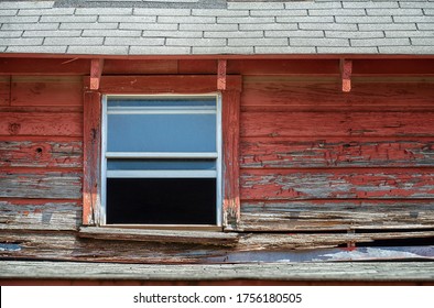 Window Of An Old Abandoned And Weathered Red Barn. Closeup.