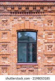 The Window Of The Old Mansion 19 Century With Brown Bricks Wall. Brick Wall Of An Old 19th Century Building With Large Window.