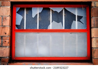 Window On Building With Broken Glass Shattered By Vandalism Destruction